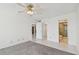 Bedroom with neutral carpeting, white walls, ceiling fan, and access to bathroom at 17900 Gulf Blvd # 16C, Redington Shores, FL 33708