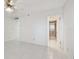 Neutral bedroom with tiled flooring leading to bathroom with shower and white doors at 17900 Gulf Blvd # 16C, Redington Shores, FL 33708