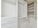 Bright walk-in closet featuring custom shelving and storage drawers for organized living at 17900 Gulf Blvd # 16C, Redington Shores, FL 33708