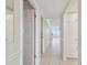 Bright hallway with tile floors and white cabinets offering ample storage space at 17900 Gulf Blvd # 16C, Redington Shores, FL 33708