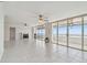 Living room with tile floors, fireplace and glass sliders to a balcony overlooking ocean at 17900 Gulf Blvd # 16C, Redington Shores, FL 33708
