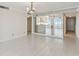 Bright living room with tile flooring, chandelier lighting and views to kitchen and entry hall at 17900 Gulf Blvd # 16C, Redington Shores, FL 33708
