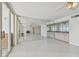 Open concept living room with tile floors, mirrored wall, wet bar, and ocean view balcony at 17900 Gulf Blvd # 16C, Redington Shores, FL 33708