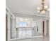 Living room with mirrored accent wall and chandelier at 17900 Gulf Blvd # 16C, Redington Shores, FL 33708