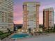 Condos shown with pool and exercise area in an aerial view with a beautiful sunset at 17900 Gulf Blvd # 16C, Redington Shores, FL 33708
