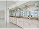 Wet bar with countertop, sink, cabinets and mirrored backsplash reflected in mirrored wall at 17900 Gulf Blvd # 16C, Redington Shores, FL 33708