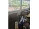 Damaged room with missing drywall and debris by window at 1831 Pasadena Dr, Dunedin, FL 34698