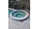 Inviting backyard with a round jacuzzi, perfect for relaxation and outdoor enjoyment at 1831 Pasadena Dr, Dunedin, FL 34698