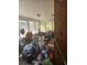 Overcrowded bonus room with light coming in through jalousie windows at 1831 Pasadena Dr, Dunedin, FL 34698