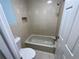 Tiled bathroom featuring a tub and shower combination, providing a functional bathing space at 2027 Pine Chace Ct, Tampa, FL 33613