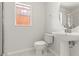 Bathroom featuring pedestal sink, shower, tile floors, and a bright window at 2032 Sunset Meadow Dr, Clearwater, FL 33763