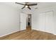 Bedroom featuring wood-look floors, a ceiling fan, and closet at 2032 Sunset Meadow Dr, Clearwater, FL 33763
