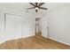Bedroom with wood floors, a ceiling fan and closet doors at 2032 Sunset Meadow Dr, Clearwater, FL 33763