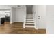 Entryway featuring a staircase with wood treads, wood floors and modern white doors at 2032 Sunset Meadow Dr, Clearwater, FL 33763