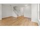 Bright hallway with wood floors leading to the staircase and other rooms at 2032 Sunset Meadow Dr, Clearwater, FL 33763
