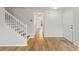 Hallway with wood floors, stairs and white doors leading to other rooms at 2032 Sunset Meadow Dr, Clearwater, FL 33763