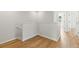 Upstairs hallway featuring wood floors and an access point to additional rooms at 2032 Sunset Meadow Dr, Clearwater, FL 33763