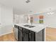 Contemporary kitchen island with stainless sink, ample storage, and modern lighting at 2032 Sunset Meadow Dr, Clearwater, FL 33763