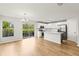 Bright, modern kitchen features stainless appliances, island, and hardwood floors at 2032 Sunset Meadow Dr, Clearwater, FL 33763