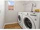 Laundry room featuring modern washer and dryer units, plus a window at 2032 Sunset Meadow Dr, Clearwater, FL 33763