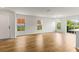 Spacious, light-filled living room with wood floors and multiple windows showcasing the outdoor views at 2032 Sunset Meadow Dr, Clearwater, FL 33763