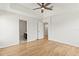 Main bedroom with wood floors, a ceiling fan and views into the en-suite bathroom at 2032 Sunset Meadow Dr, Clearwater, FL 33763