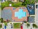 Aerial view of community pool, featuring lounge chairs, playground, and ample parking at 2032 Sunset Meadow Dr, Clearwater, FL 33763