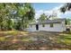 Wide shot of backyard showing rear exterior and tree coverage at 2220 3Rd E Ave, Bradenton, FL 34208