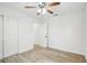 Spacious bedroom featuring wood-look floors, ceiling fan, and walk-in closet at 2220 3Rd E Ave, Bradenton, FL 34208