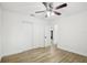 Bright bedroom featuring wood-look floors, ceiling fan, and closet with white doors at 2220 3Rd E Ave, Bradenton, FL 34208