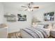 Bright bedroom featuring a ceiling fan, a comfortable bed, two windows and decorative shelves with toys at 2220 3Rd E Ave, Bradenton, FL 34208