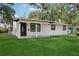 Beautiful well-manicured lawn, freshly painted exterior with black and white paint job at 2220 3Rd E Ave, Bradenton, FL 34208