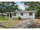 Charming home with a black door, new windows and freshly trimmed lawn at 2220 3Rd E Ave, Bradenton, FL 34208