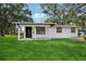 This home has a well-manicured lawn with trimmed trees, fresh black and white paint job at 2220 3Rd E Ave, Bradenton, FL 34208