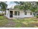 Charming home with a freshly cut lawn, and dark accents to the door and windows at 2220 3Rd E Ave, Bradenton, FL 34208