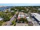 Aerial view of townhomes along street with surrounding neighborhood, landscaping, and harbor views at 230 Columbia Dr, Tampa, FL 33606