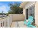 Relaxing balcony features a blue chair, neutral rug, and natural light streaming through sliding glass doors at 230 Columbia Dr, Tampa, FL 33606