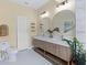 Bathroom featuring a double vanity with gold accents, white hexagon floors, and a closet at 230 Columbia Dr, Tampa, FL 33606