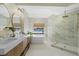 Modern bathroom with double vanity, soaking tub, walk-in shower, and marble accents at 230 Columbia Dr, Tampa, FL 33606