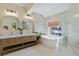 Modern bathroom with double vanity, soaking tub, walk-in shower, and marble accents at 230 Columbia Dr, Tampa, FL 33606