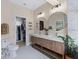 Bathroom featuring a double vanity with gold accents, white hexagon floors, and a closet at 230 Columbia Dr, Tampa, FL 33606