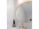 Bathroom featuring a round mirror, modern fixtures, and marble countertops at 230 Columbia Dr, Tampa, FL 33606