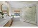 Modern bathroom with double vanity, soaking tub, walk-in shower, and marble accents at 230 Columbia Dr, Tampa, FL 33606