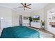 Bright bedroom with ceiling fan, ensuite bathroom, a desk, and modern white dresser at 230 Columbia Dr, Tampa, FL 33606