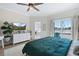 Well-lit bedroom with access to balcony, ceiling fan, desk and ensuite bathroom at 230 Columbia Dr, Tampa, FL 33606