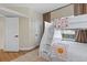 Cozy bedroom featuring carpeted floors, bunkbeds, and a bright window at 230 Columbia Dr, Tampa, FL 33606