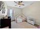 Comfortable bedroom with stylish décor, ceiling fan, natural light, and coordinated furniture at 230 Columbia Dr, Tampa, FL 33606