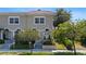 Charming home exterior featuring a well-manicured lawn, garden beds, and lovely architectural details and landscaping at 230 Columbia Dr, Tampa, FL 33606