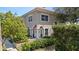 Inviting two-story home with lush landscaping and an American flag displayed at the front entrance at 230 Columbia Dr, Tampa, FL 33606