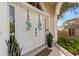Inviting double front doors with decorative wreaths, flanked by plants and a 'WELCOME' sign at 230 Columbia Dr, Tampa, FL 33606